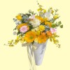 Full sunflowers, cream roses, pink gerbera, yellow tulips, white line flowers, blue accents and oncidium in a white bucket