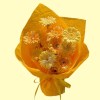 Full cream, apricot and orange gerbera with pearl, bow and iridescent accents in warm orange wrapping