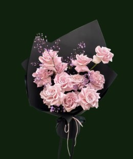 Pale pink roses with airy filler flowers in black and blush wrapping