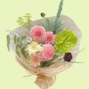Full green anthurium, pink pompon dahlias, pale gerbera, burgundy scabiosa, yellow umbels, and fern foliage
