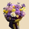 Full lilac chrysanthemums, violet iris, purple hydrangea, yellow orchids, creamy roses, and bright yellow accents