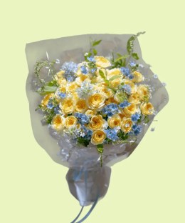 Full yellow garden roses with blue tweedia, pale-blue delphinium, white Queen Anne's lace, and fresh greenery