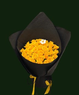 Lush yellow roses with light floral accents in dramatic black wrapping.